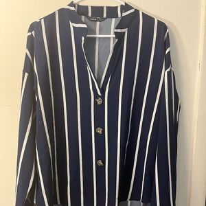 Stripped blue and white blouse buttons are brown with design print